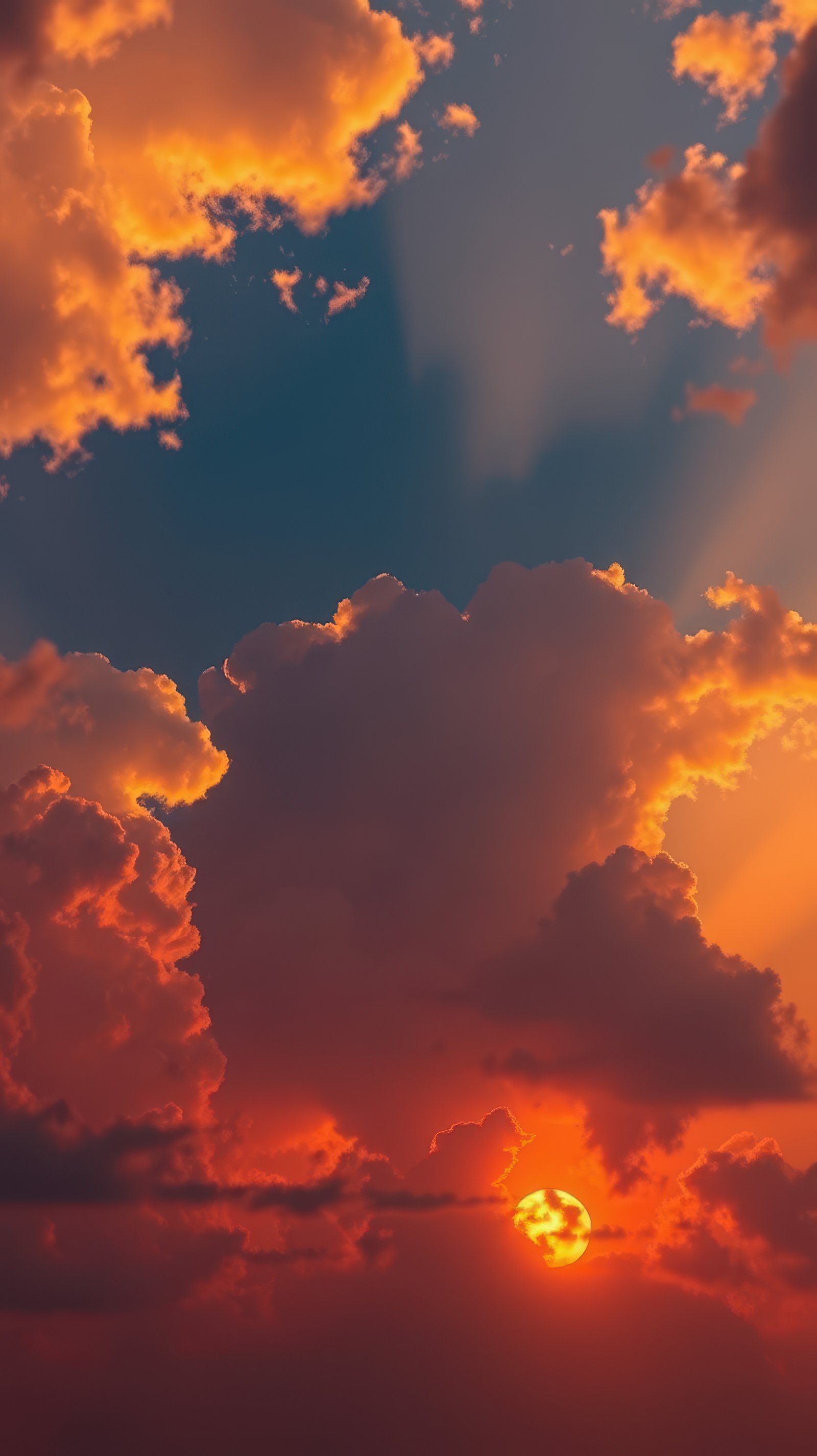 Vibrant sunset casts orange and golden hues over calm ocean waves reflecting the colorful sky